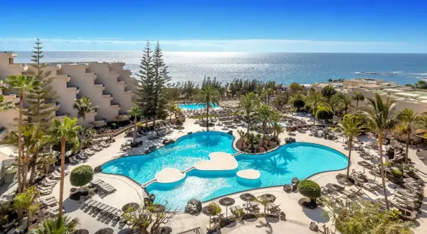 Barceló Lanzarote Active Resort: luksusowy kompleks z basenami, palmami i widokiem na ocean. Idealne miejsce na aktywny wypoczynek.