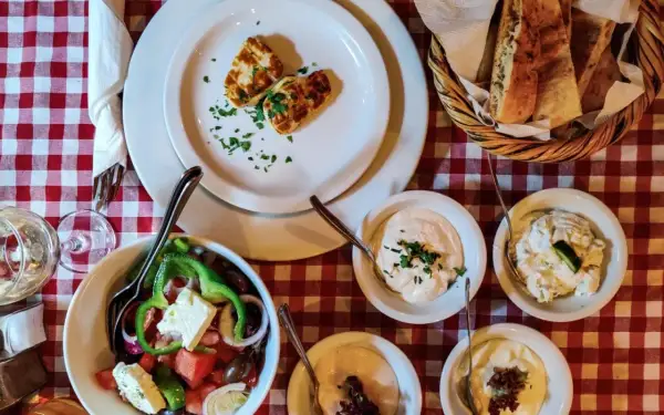 Pyszne jedzenie z Cypru: sałatka grecka, halloumi, pieczywo i dipy. Idealny posiłek na wakacjach.